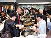 The guests and graduates enjoying a buffet lunch after the Graduation Ceremony
